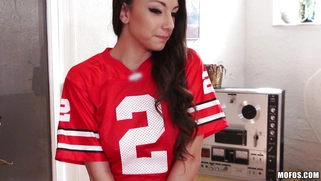 Miss Rican in a panties and footbal team t-shirt plays a video game