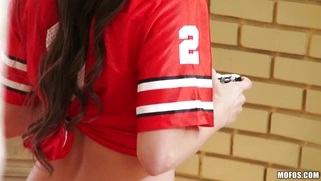 Miss Rican in a panties and footbal team t-shirt plays a video game