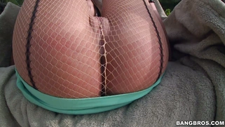 August Ames wearing fishnet pantyhose and posing outdoor