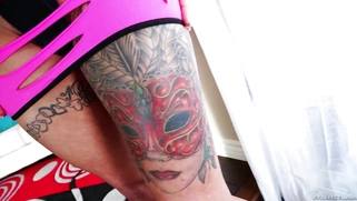 Red-haired punkette Anna Bell Peaks demonstrates her tattoos