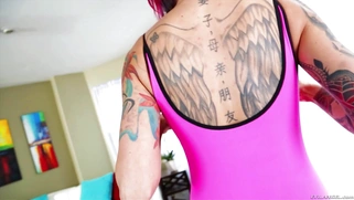 Red-haired punkette Anna Bell Peaks demonstrates her tattoos