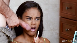 Ebony Scarlit Scandal is sucking the white cock in the bathroom