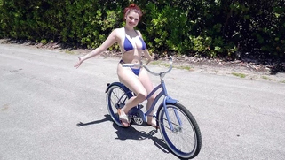 Annabel Redd is riding the bike and showing off her big boobs