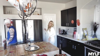 Katie Morgan is cleaning the kitchen while the guys are watching a game