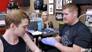 Natasha James is sucking her stepson's cock in the tattoo parlor