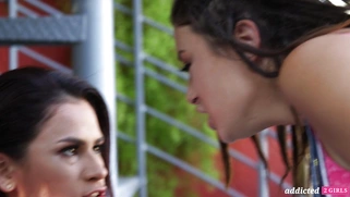 Vanessa Veracruz and Daisy Haze are kissing outdoors
