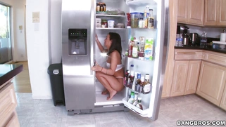 Amara Romani in her underwear cleaning the fridge