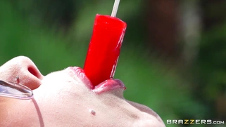 Peta Jensen sucks on a popsicle, posing by the pool