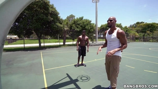 Michelle Martinez playing basketball with three black muscle dudes