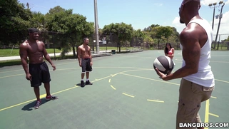 Michelle Martinez playing basketball with three black muscle dudes