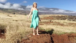 Gorgeous blonde Anikka Albrite posing among cloud-shrouded mountains