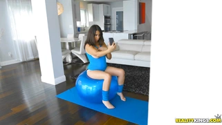 Nina Lopez bouncing up and down on a giant workout ball