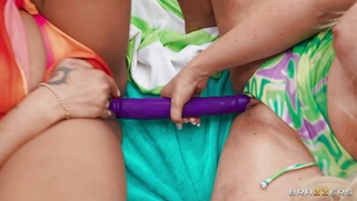 Kayley Gunner and Kona Jade share the dildo outdoors