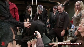 Tied and shrouded in a black sheet