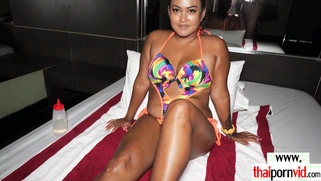 Thai MILF feeding her hungry asian pussy