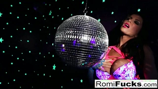 Romi Rain stuffs her pussy after playing with a disko ball.