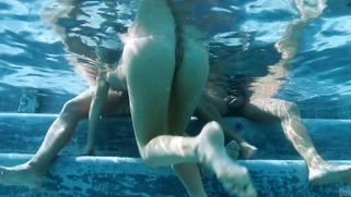 Samantha Saint stroking two dicks underwater