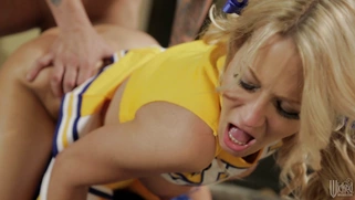 Jessica Drake in a cheerleader outfit takes it doggie